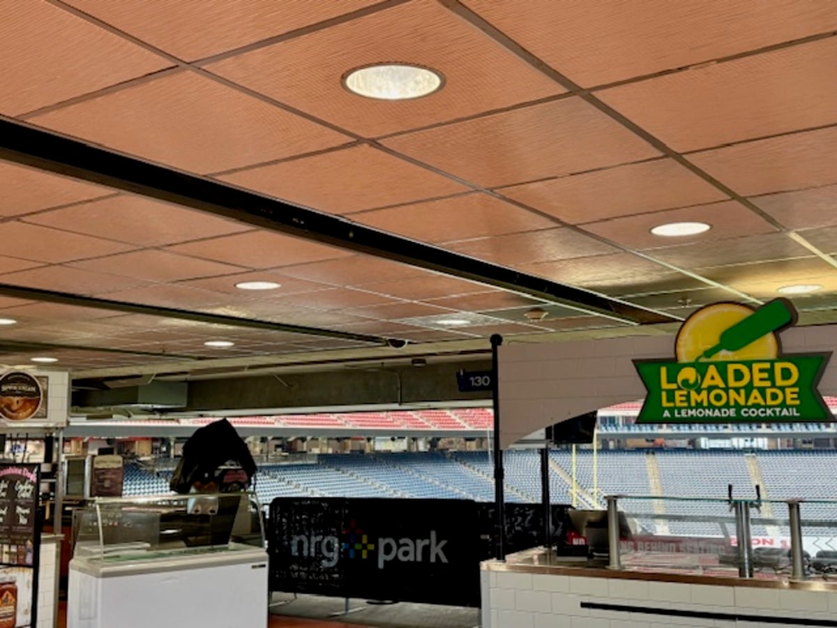 Indoor Sporting Venue Concession with a Loaded Lemonade Sign Near a Counter and Seating Visible in the Background