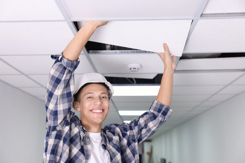 Suspended,Ceiling,Installation.,Builder,Working,With,Pvc,Tile,Indoors Contractor installing a suspended PVC ceiling system in a commercial interior space